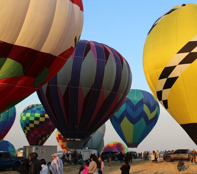 A colorful row of inflated balloons on the launch field