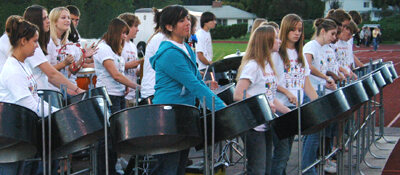 Young musicians performing on steel drums at a past rally event